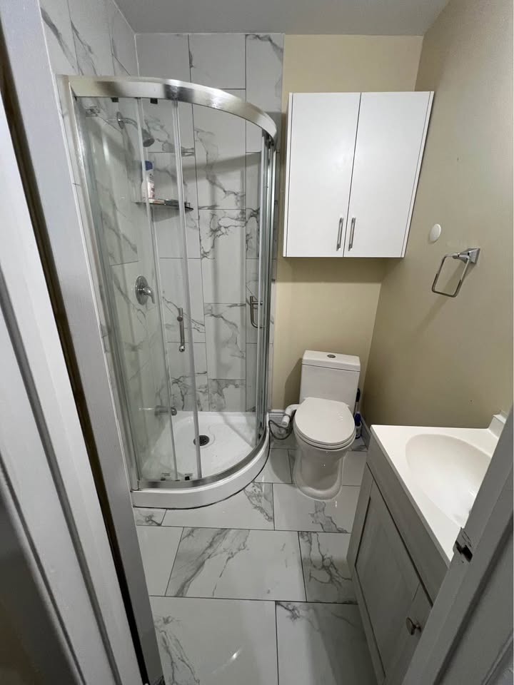 Spotless bathroom shower and floors after a post-construction clean in Brampton