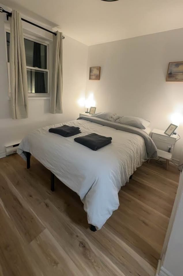 Freshly made bed and clean floors after a move-out clean in Mississauga