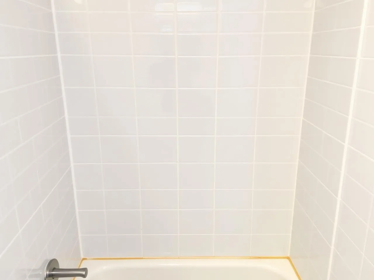 Restored white shower tile and grout after deep bathroom cleaning
